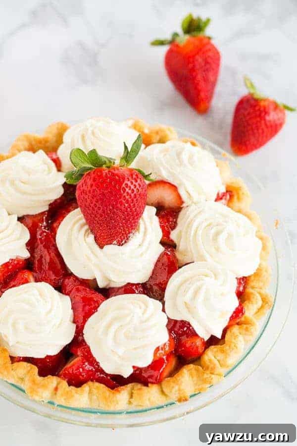 A stunning Fresh Strawberry Pie, completely homemade with a favorite crust, delicious glaze, and sweet whipped cream, presented as a perfect summer dessert.