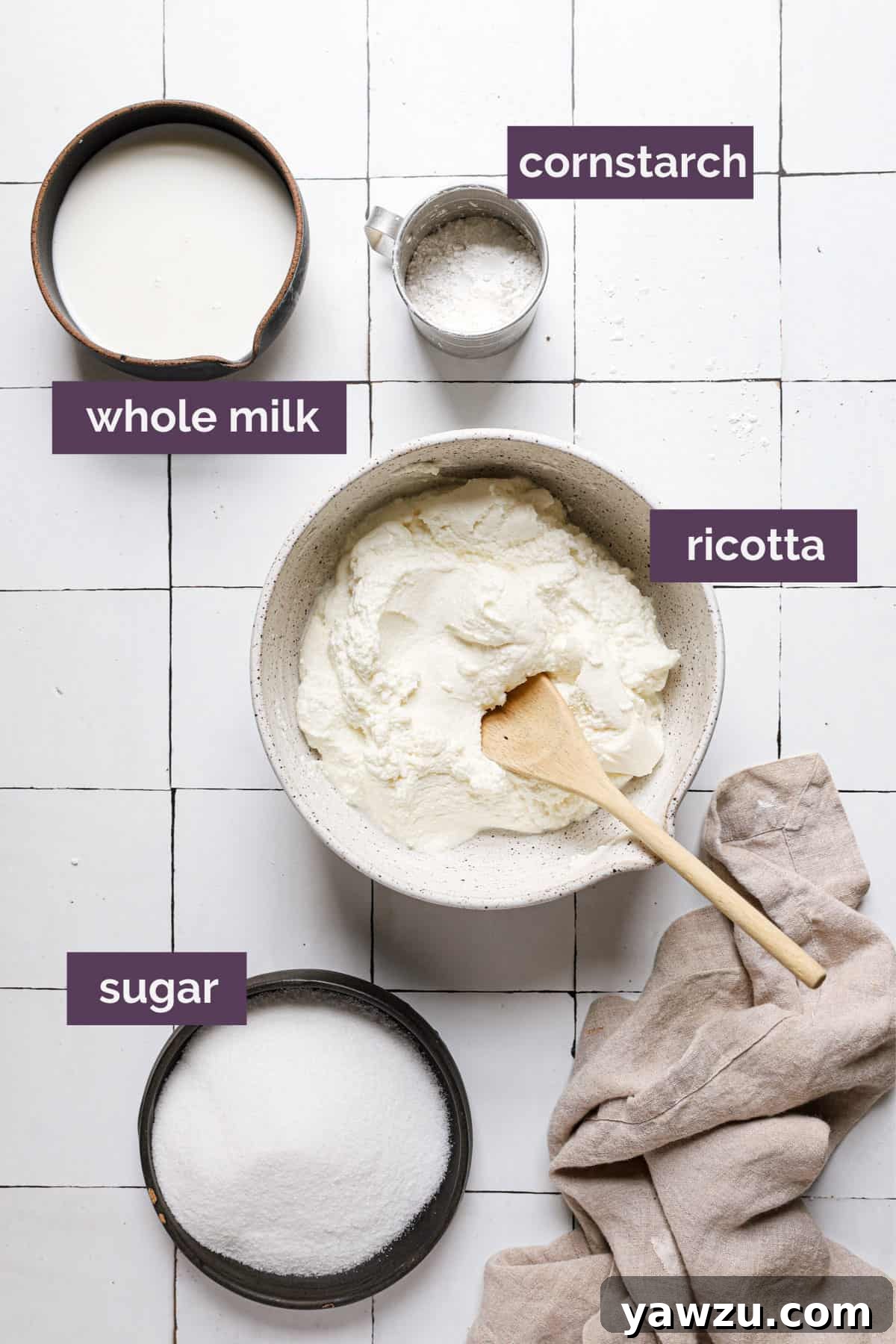 Ingredients for cannoli on a tile counter with purple labels.