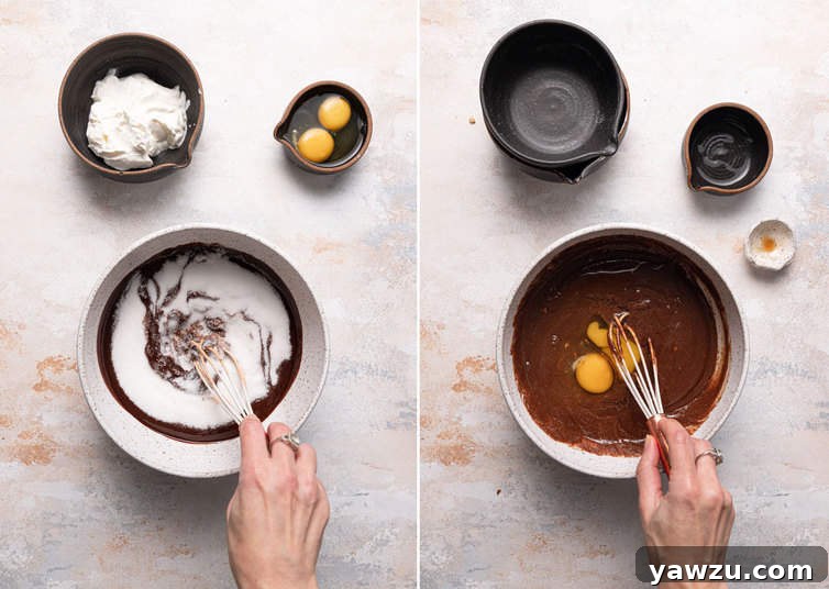 Close-up shot of a whisk combining melted chocolate, butter, sugar, sour cream, vanilla, and eggs in a glass bowl, creating a smooth and glossy wet mixture for chocolate muffins.