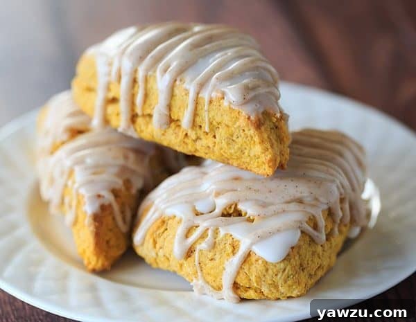 Pumpkin Scones with Spiced Glaze - A Starbucks copycat! | https://www.browneyedbaker.com/pumpkin-scones-spiced-glaze/