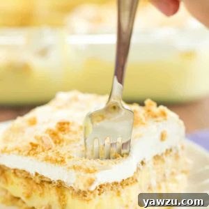 A piece of icebox cake with a fork digging right in!