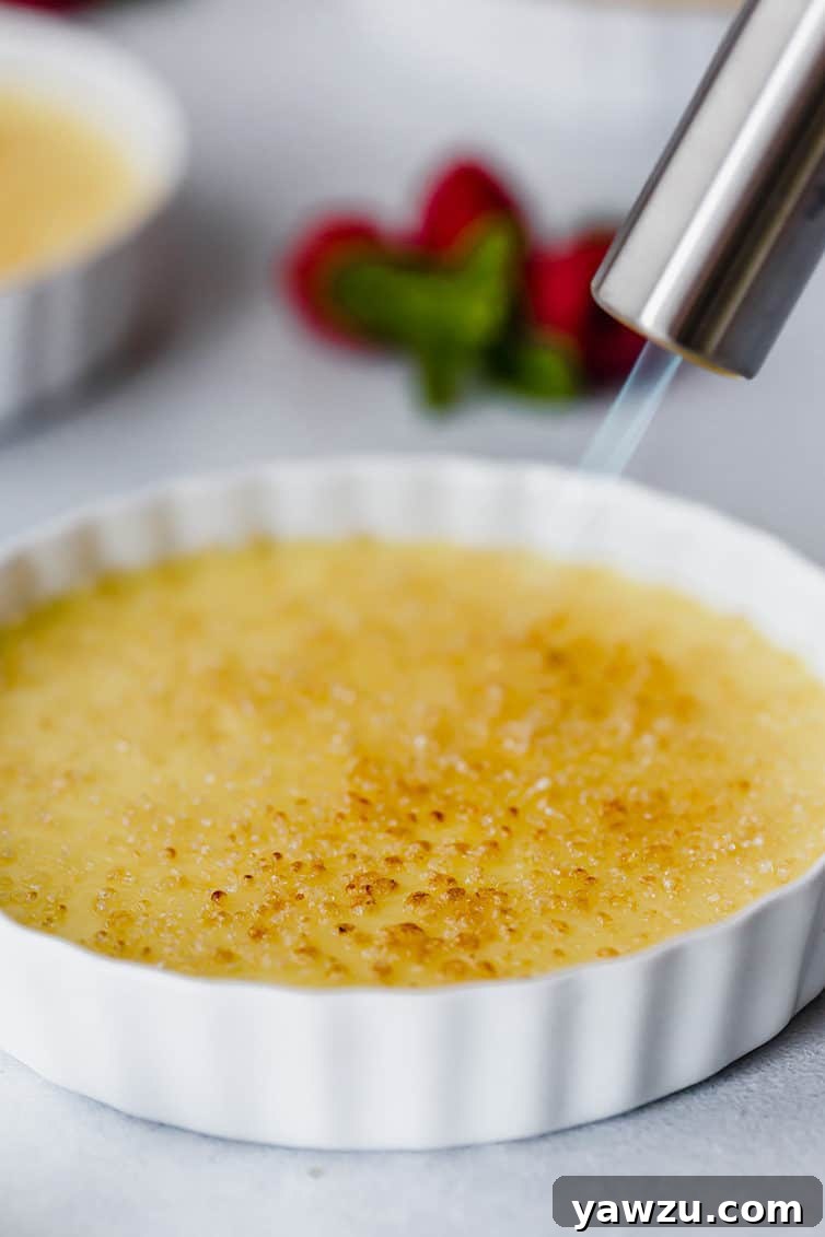Crème Brûlée being torched to create a caramelized sugar topping.