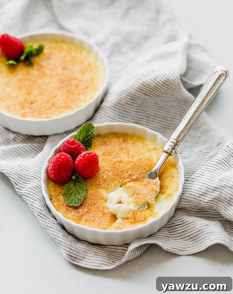 Two ramekin bowls of perfectly torched creme brulee.
