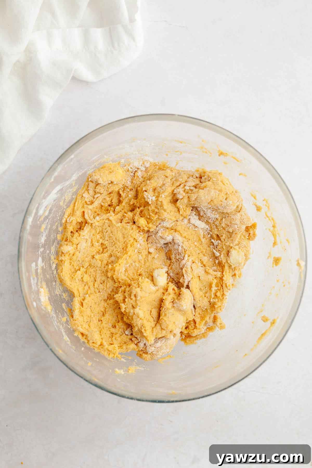 Glass bowl with pumpkin scones dough.