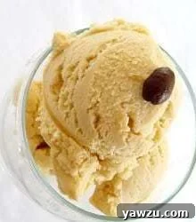 Scoops of espresso ice cream in a glass bowl topped with an espresso bean.