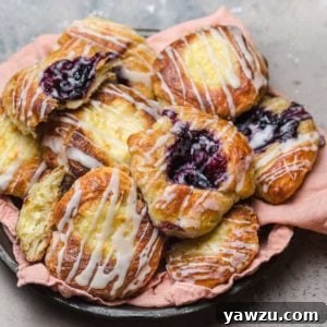Freshly baked Danish pastries with various fillings on a platter.