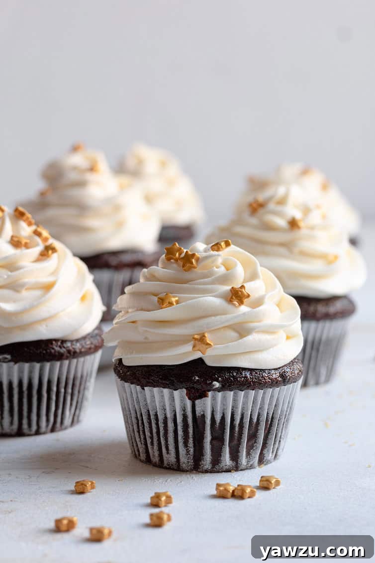 Chocolate cupcakes topped with perfect cream cheese frosting, showcasing its delightful texture and aesthetic appeal.