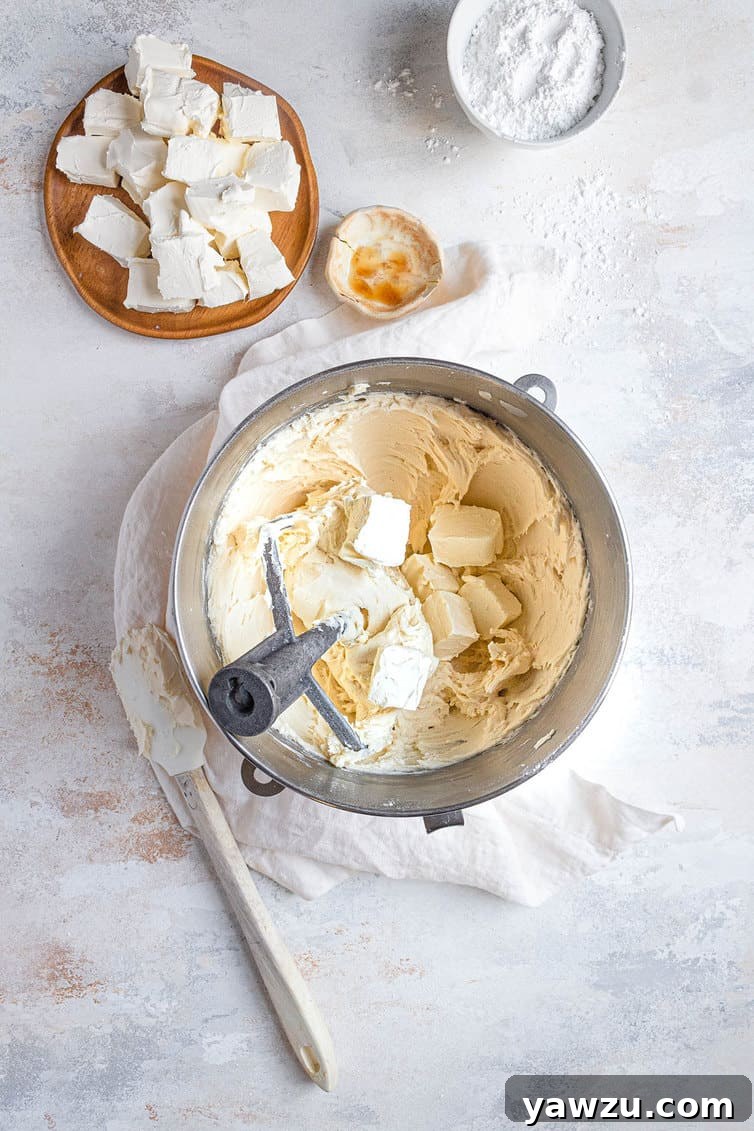 A bowl of freshly made cream cheese frosting, smooth and ready to be used, highlighting its ideal consistency.