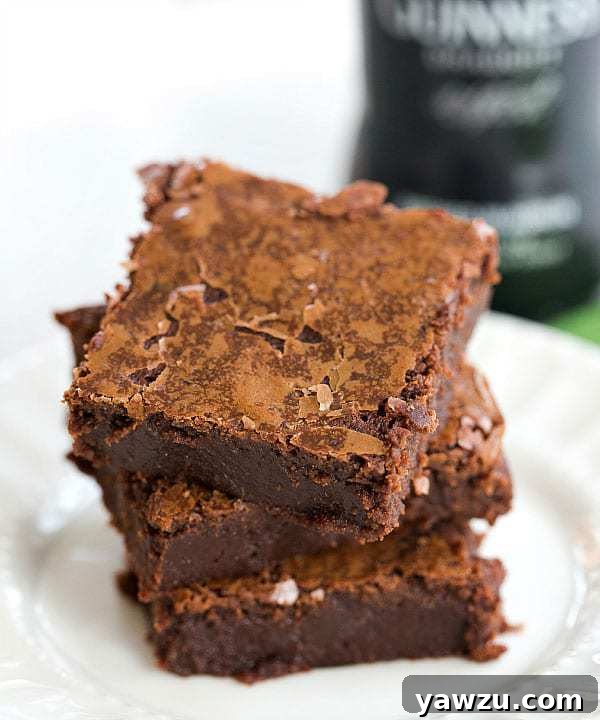 Perfectly fudgy Guinness Chocolate Brownies, dusted lightly with powdered sugar, an easy and rich dessert for St. Patrick's Day festivities.