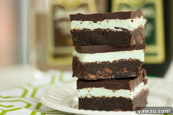 Decadent Grasshopper Brownies, featuring a rich chocolate base, a vibrant minty layer, and a glossy chocolate ganache topping, ideal for St. Patrick's Day.
