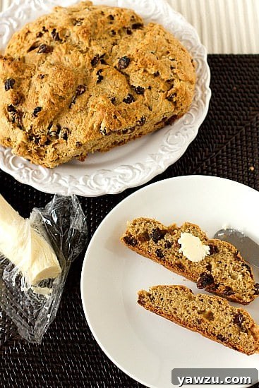 A rustic loaf of Irish Whiskey Soda Bread, served with a generous dollop of Irish Whiskey Butter, offering a delightful kick for St. Patrick's Day.