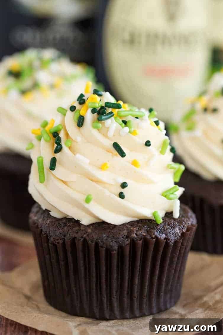 Three decadent Irish Car Bomb Cupcakes, featuring rich chocolate cake, creamy ganache, and swirls of Baileys buttercream, perfect for an adult St. Patrick's Day celebration.