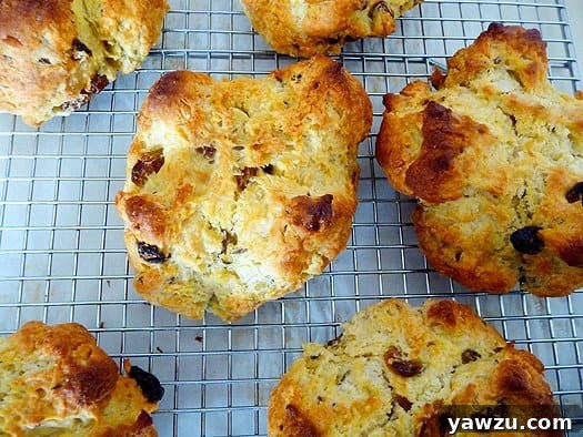 Freshly baked Irish soda bread scones cooling on a wire rack, showcasing their golden crusts.