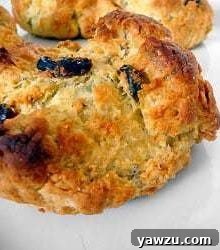 A single Irish soda bread scone on a white plate, highlighting its rustic charm.