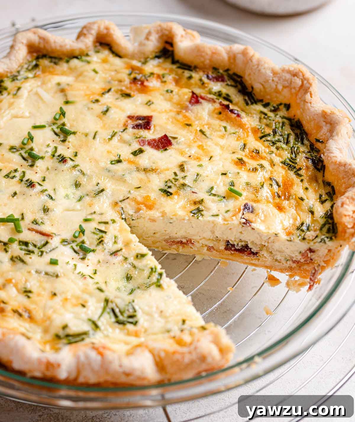 Baked quiche with a slice removed from the pan.