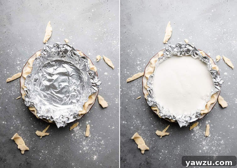 Pie dough covered in foil and filled with sugar.