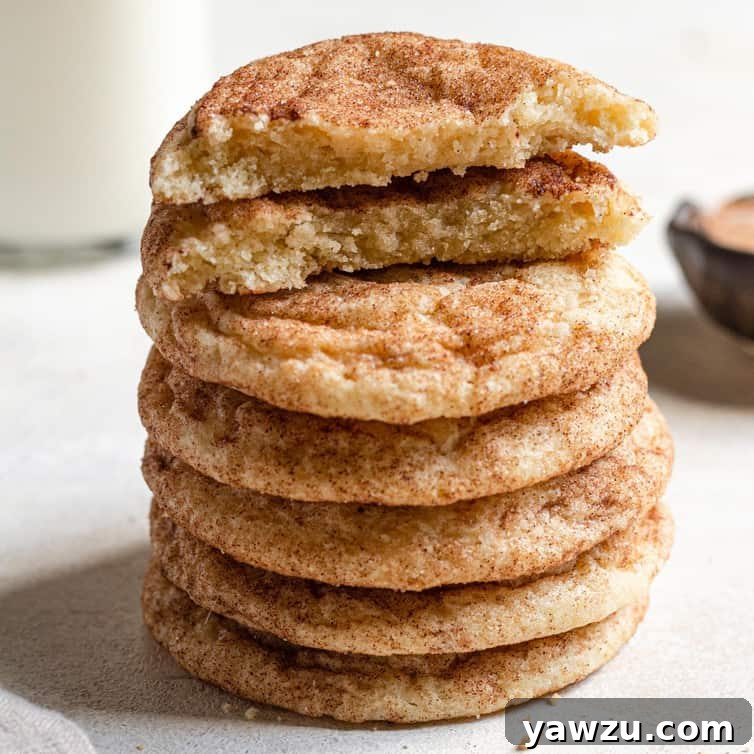 Soft and Chewy Snickerdoodles on a cooling rack, dusted with cinnamon sugar, ready for holiday baking