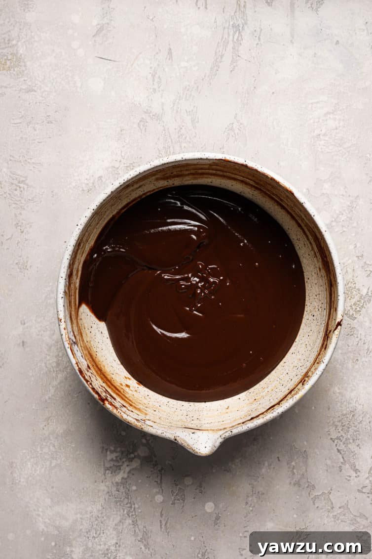 A light brown bowl filled with melted chocolate sauce.