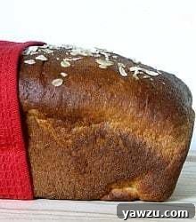Side view of a loaf of honey oatmeal sandwich bread.