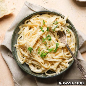 A bowl of freshly made Alfredo sauce ready to be served with pasta.
