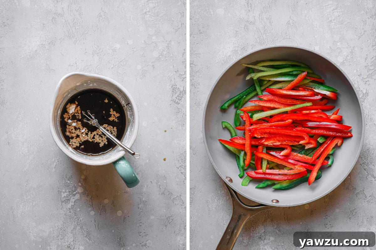 Stir fry sauce in a measuring cup ready to be poured, with red and green bell peppers sautéing in a frying pan.