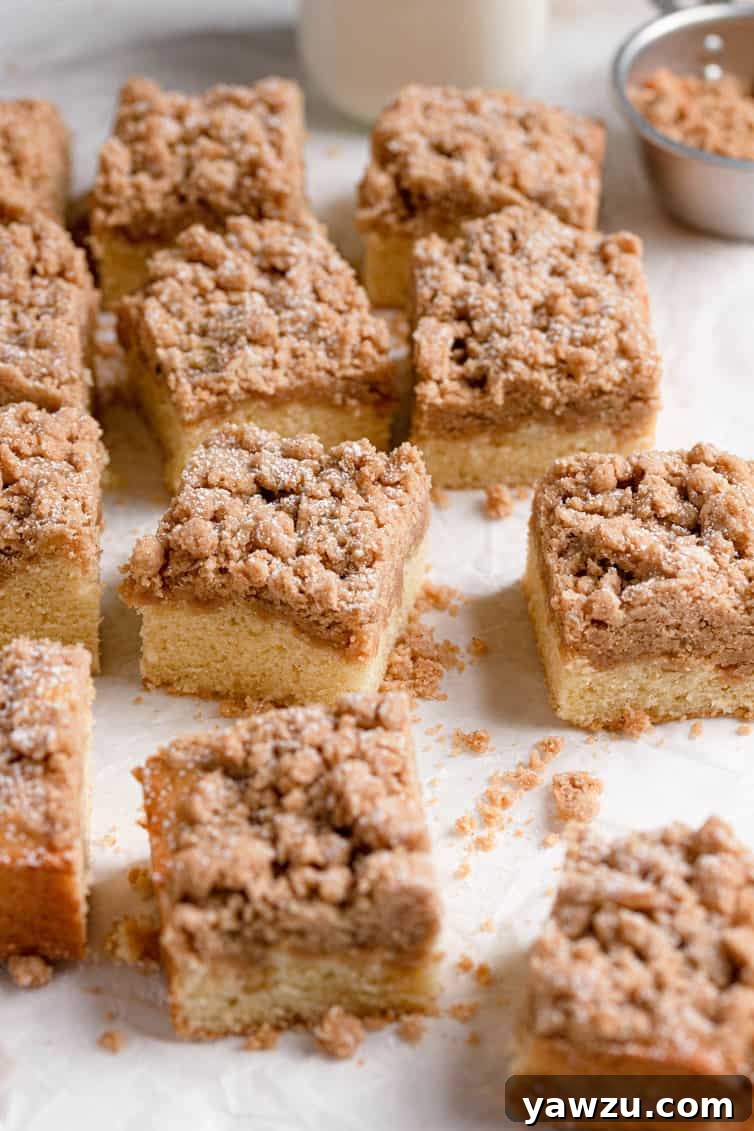 Squares of crumb cake on a cutting surface.