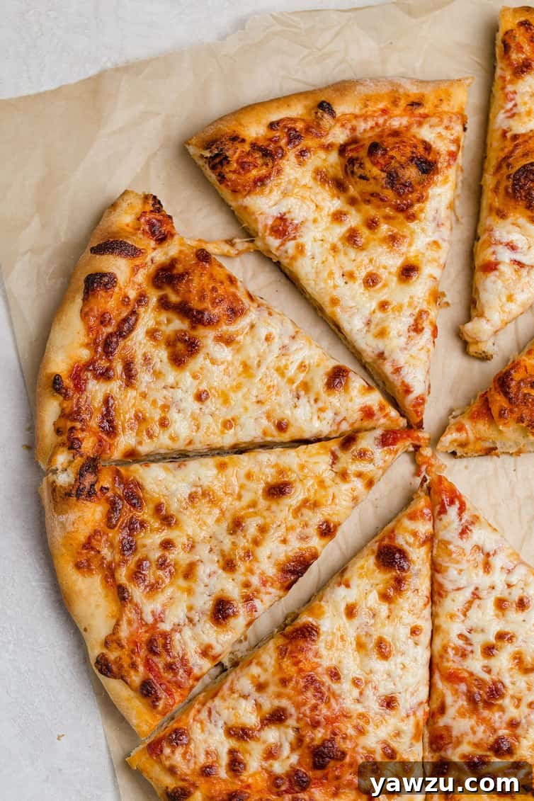 A close-up shot of a half-eaten cheese pizza, showcasing its golden-brown, crispy crust and melted, bubbling cheese, with several triangular slices already cut.