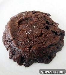 A salted chocolate shortbread cookie on a white plate.