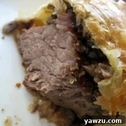 Showing the inside texture of beef Wellington.