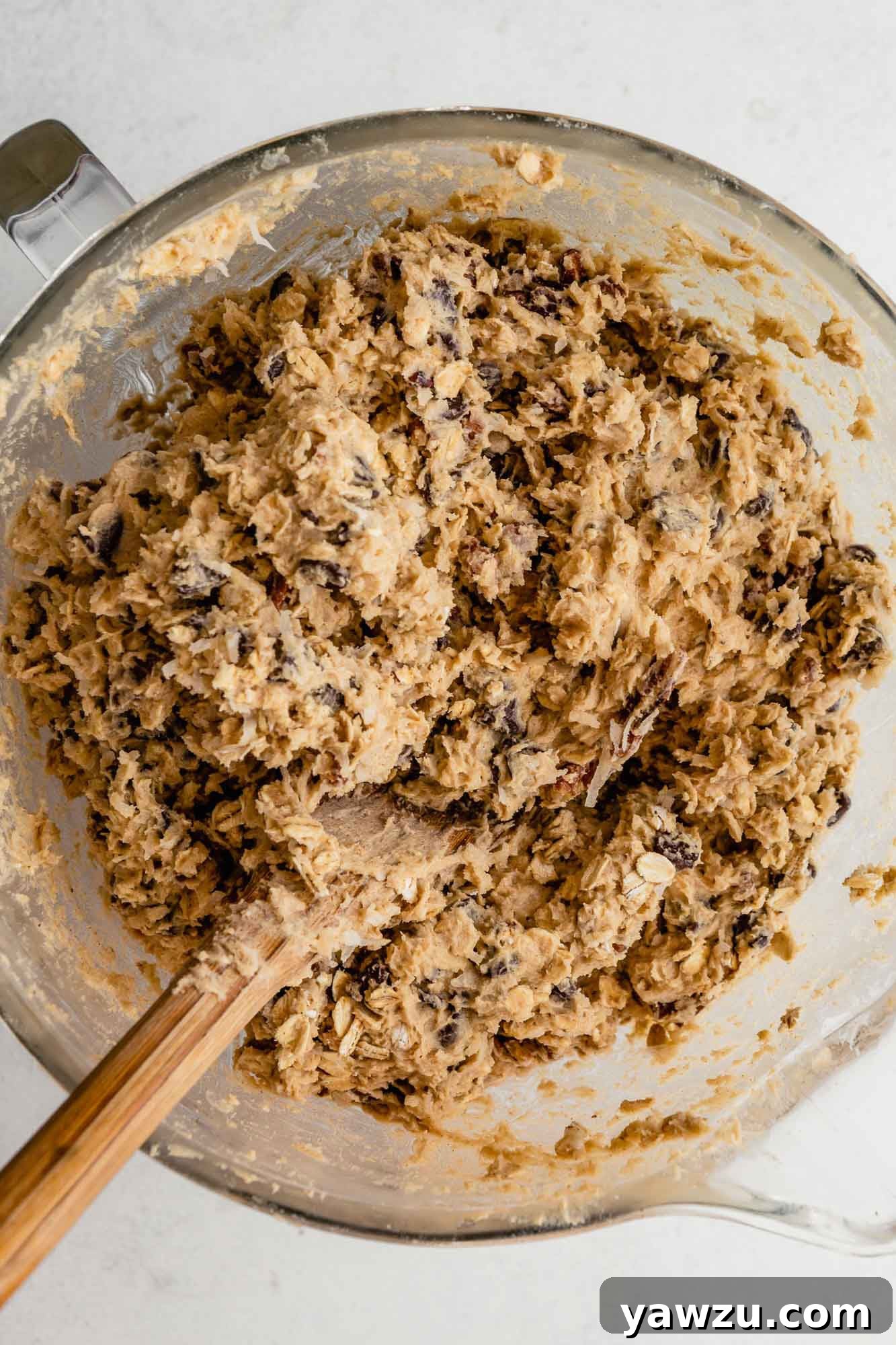 Cowboy cookie dough in a glass mixing bowl.