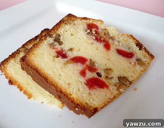 Multiple slices of rich Russian pound cake arranged on a white serving plate, highlighting the cake's golden crust, moist interior, and visible cherries and walnuts.