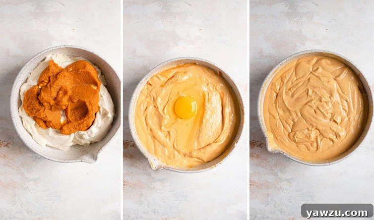 A close-up view of the rich, spiced batter for pumpkin cheesecake being mixed in a bowl, showcasing its creamy texture.