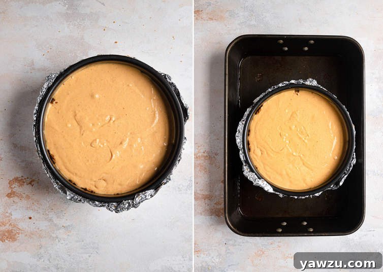 A pumpkin cheesecake, securely placed within a water bath, is ready for baking in the oven.