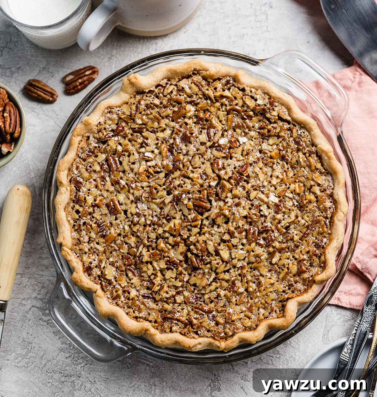 Overhead photo of baked pecan pie in a glass pie plate.