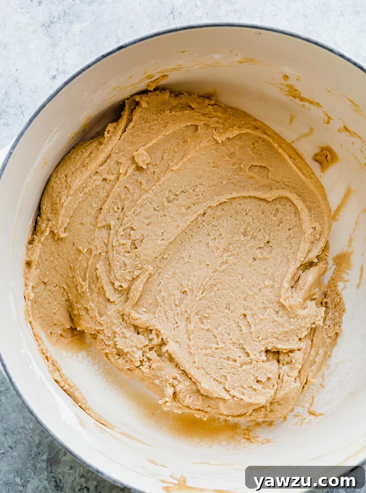 Freshly mixed peanut butter fudge in a pot, showing its creamy texture before being poured into a pan.